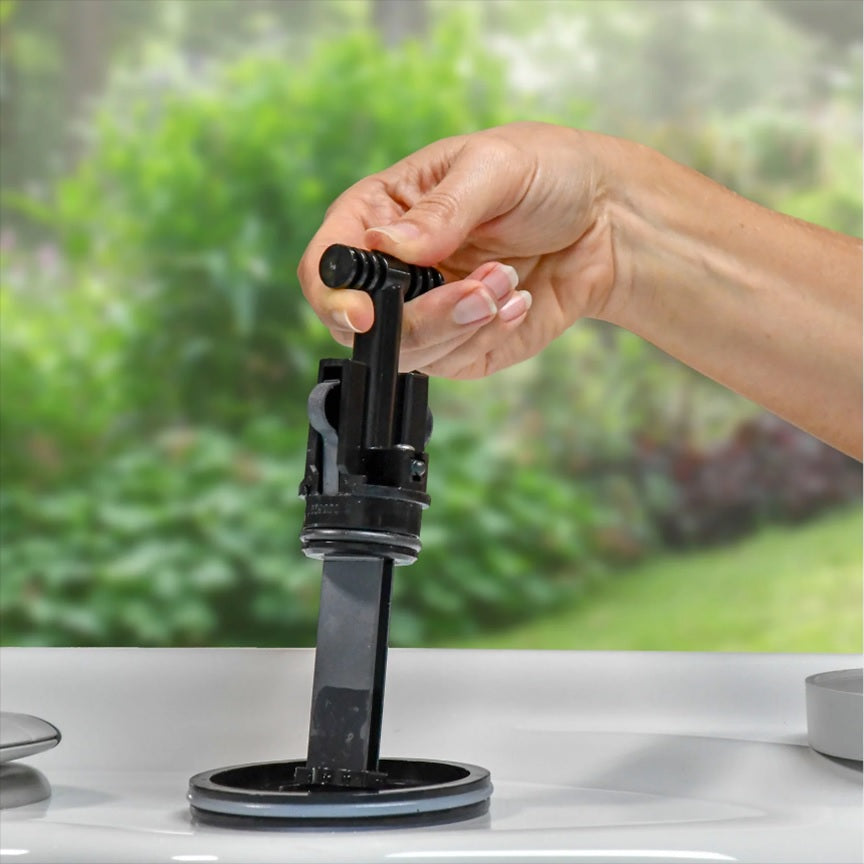 A hand pushing a cartridge into a spa