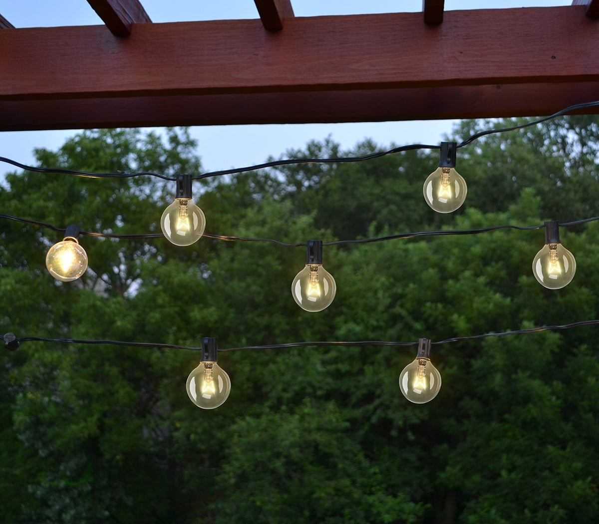 This lifestyle image shows the string of G40 light bulbs hanging in a backyard.