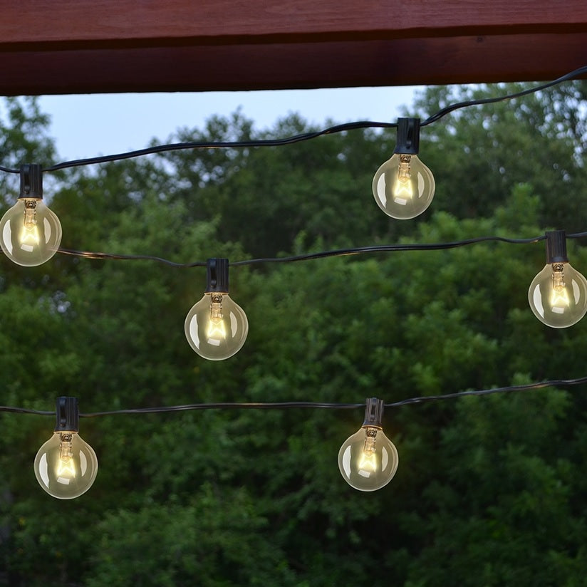 This lifestyle image shows the string of G40 light bulbs hanging in a backyard.