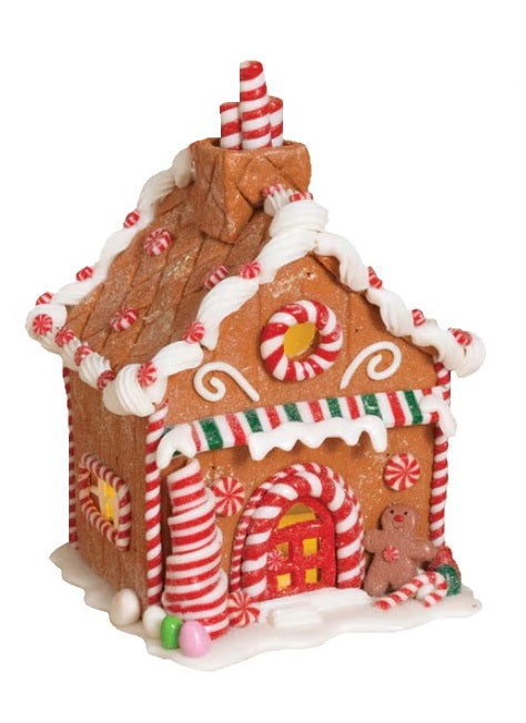 Tabletop decoration designed to look like a decorated gingerbread house. Features frosting, peppermint, gummy and sugar accents.