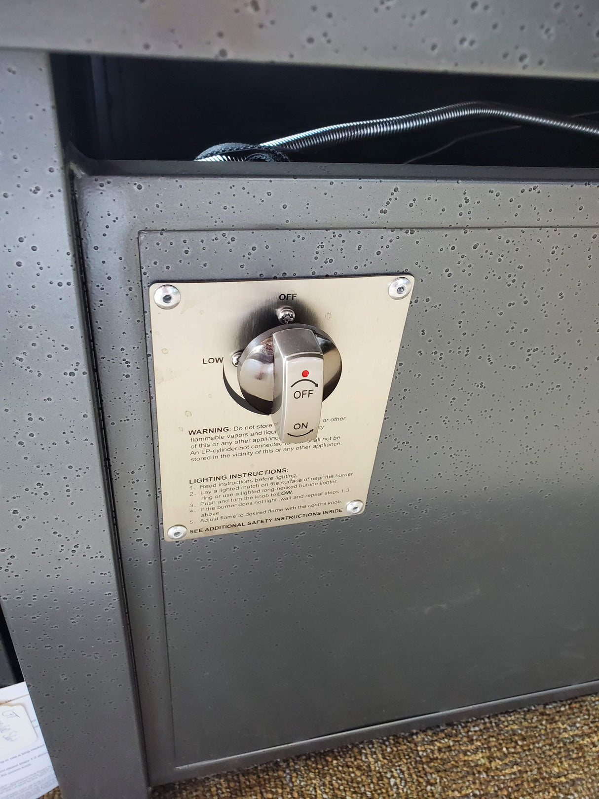 This image shows the side of the fire pit table with the ON/OFF switch.