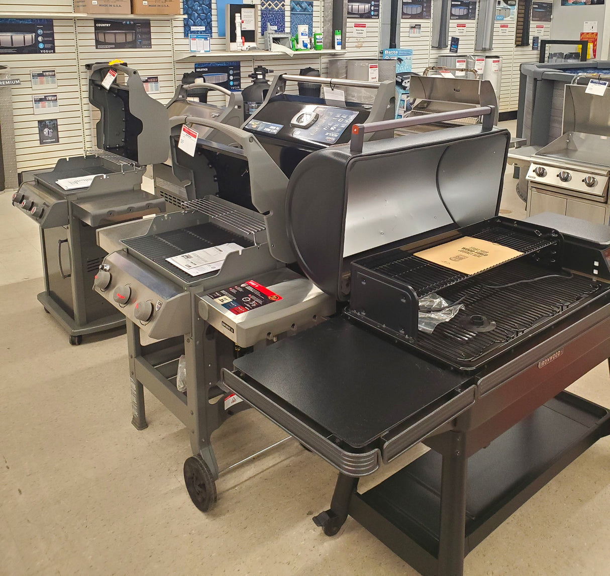 Various clearance BBQ grills on display in the Tinley Park Outlet store.