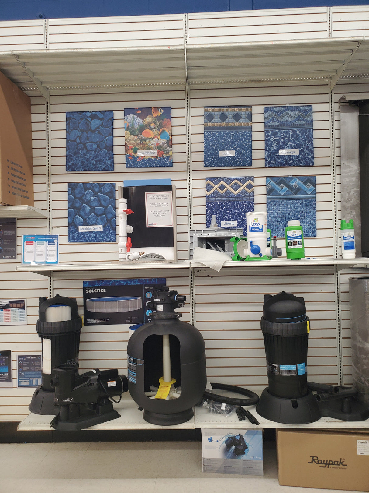 Display of above ground pool liners and pool filter equipment at the Tinley Park Outlet store.