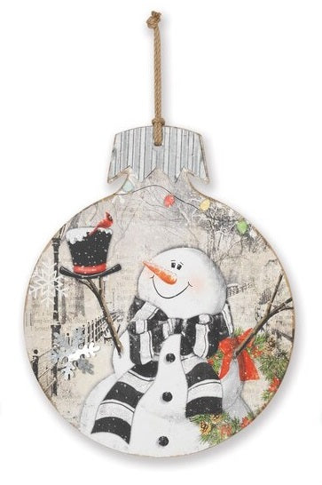 This wooden ornament features a snowman holding a top hat with a cardinal on top.