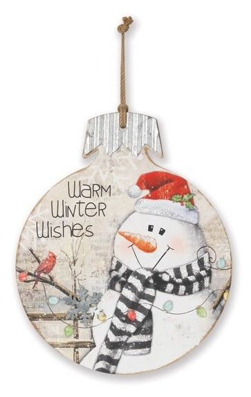 This wooden ornament reads "Warm Winter Wishes" and features a snowman wearing a Santa hat and looking at a cardinal on a tree.