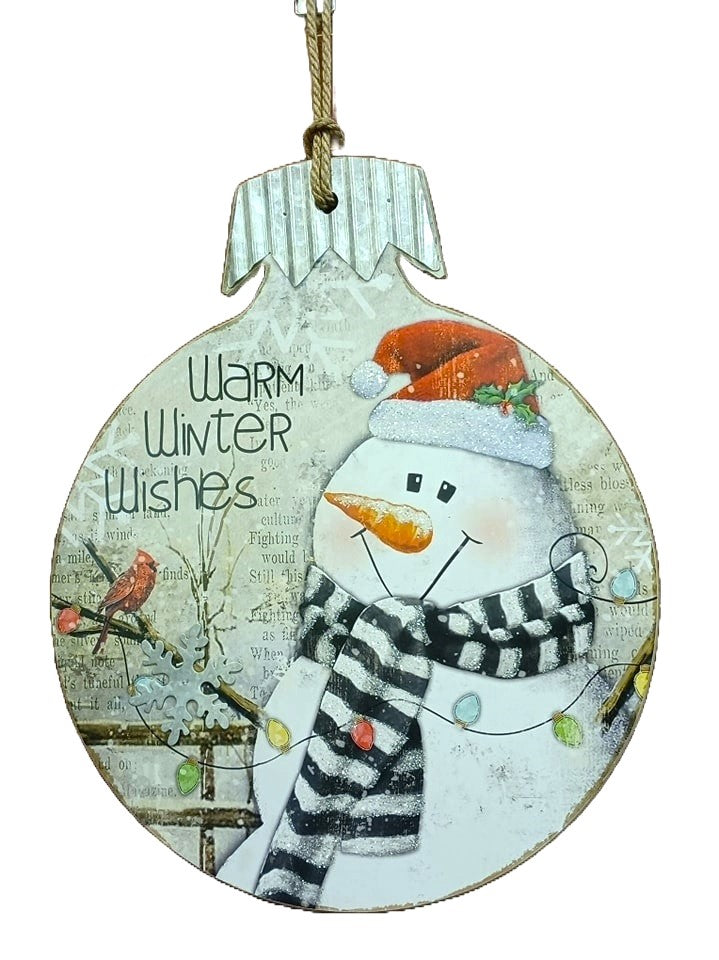 This wooden ornament reads "Warm Winter Wishes" and features a snowman wearing a Santa hat and looking at a cardinal on a tree.