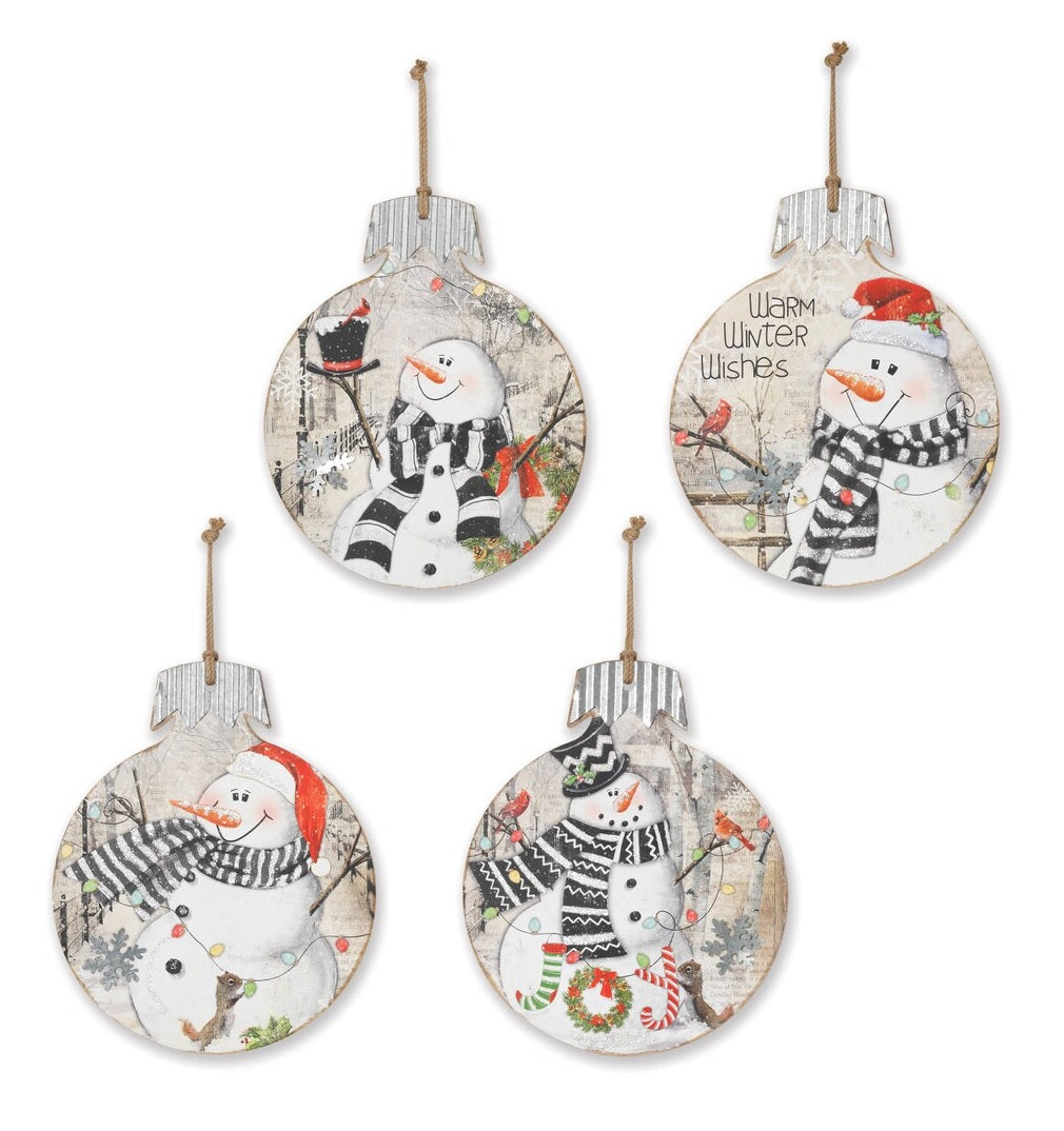 Wooden ornaments featuring smiling snowmen in rustic, winter scenes. This picture shows all four options that are available.