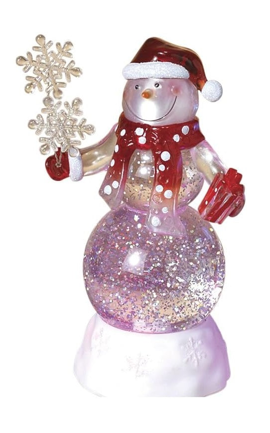 Glass snowman decoration. The snowman is wearing a red Santa hat, a red scarf with white polka dots and red gloves. He's holding two snowflakes and a red present. There's glitter inside.