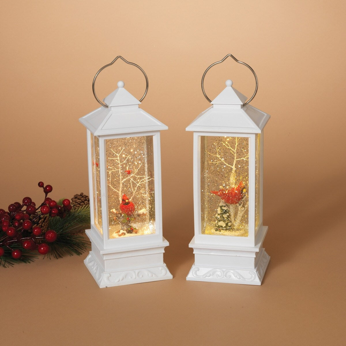 White lantern decoration with glitter and a woodland scene with a cardinal inside.