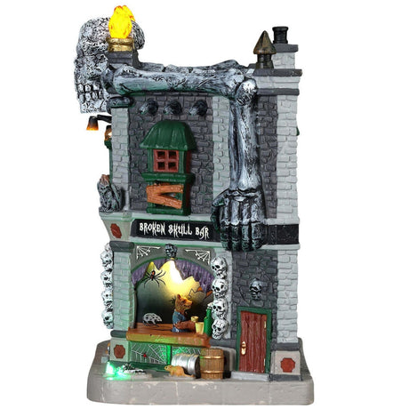 Porcelain lighted building for a Lemax display. Designed to look like a brick building with boarded up windows and skull accents. There are monsters visible inside the bar.