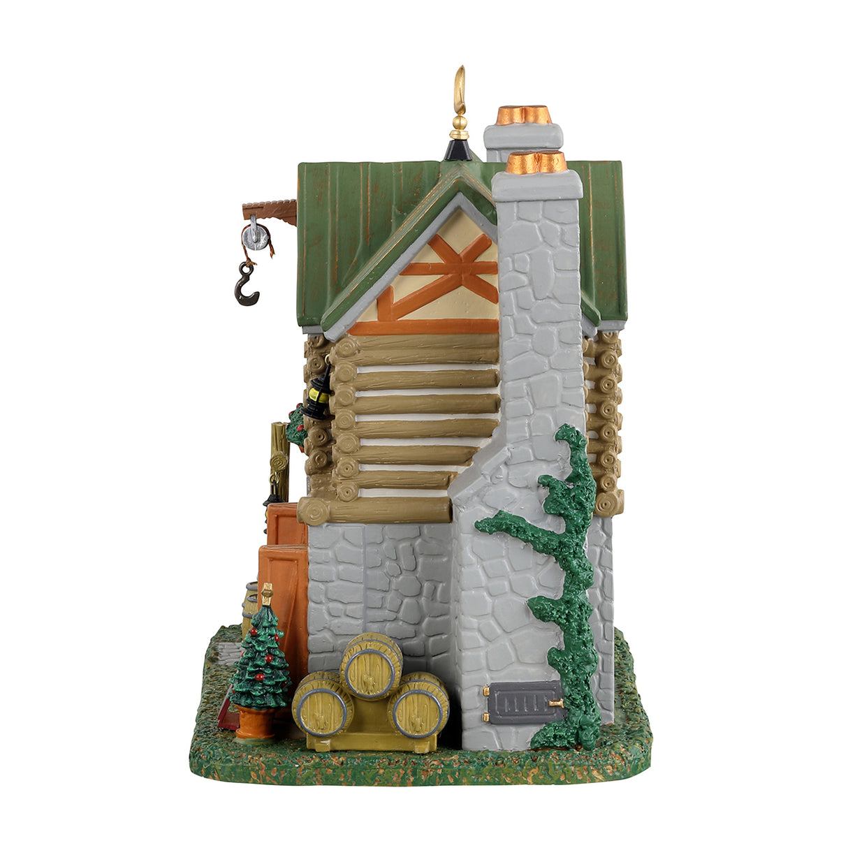 Porcelain lighted building for Lemax display. This is the side of the building. It's a stone chimney with vines going up the side. There are three barrels and a small Christmas tree.