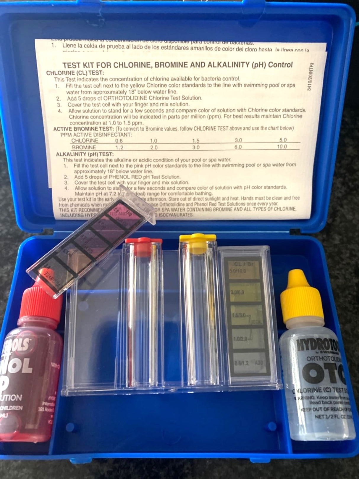 Blue container holding the water testing kit for your pool. Instructions are printed on the inside of the lid.