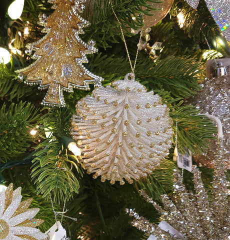 Glitter ornaments shaped like round pine cones. One is silver with gold tips and the other is gold with silver tips.