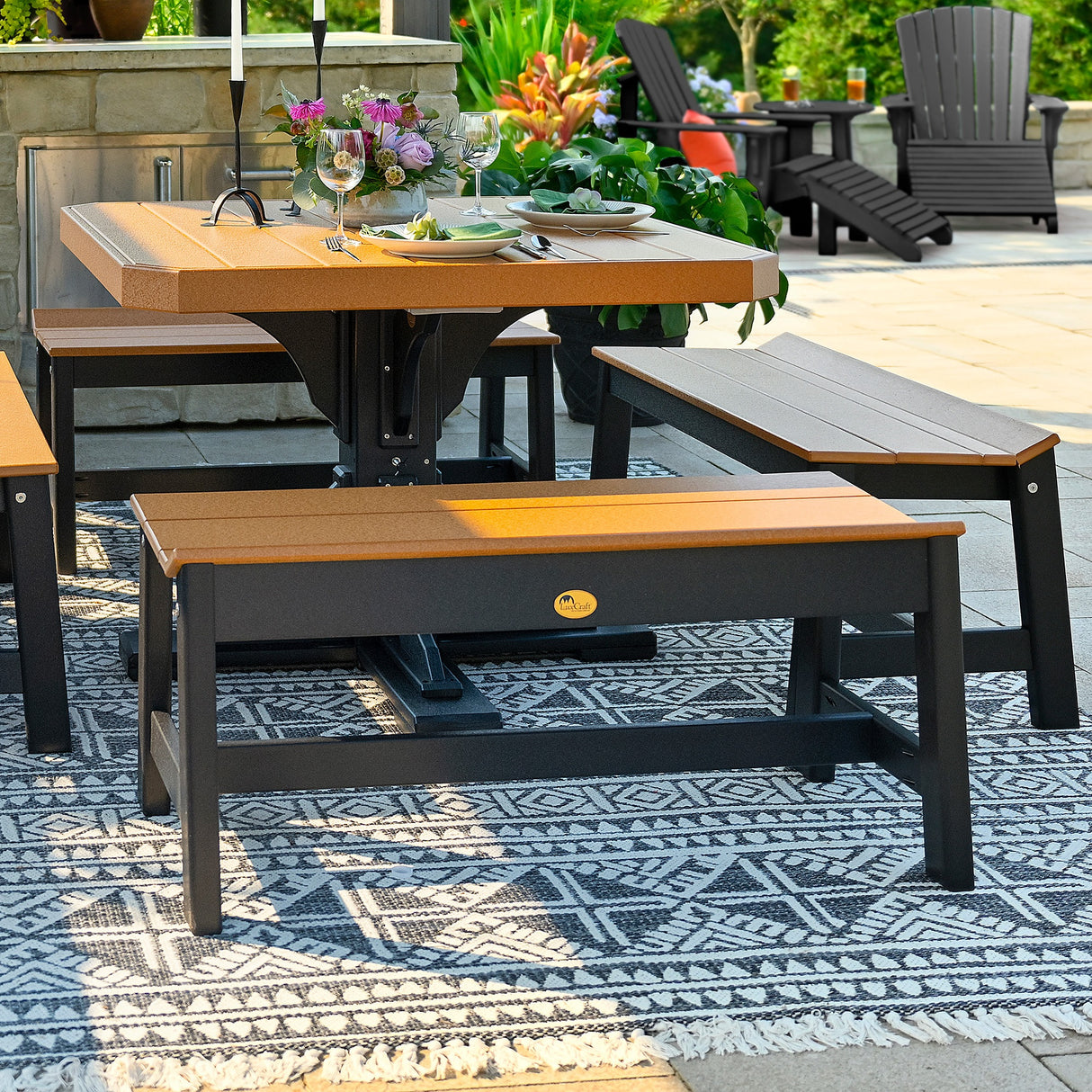 This is a lifestyle image showing four Cedar and Black colored dining benches around a matching color patio table.