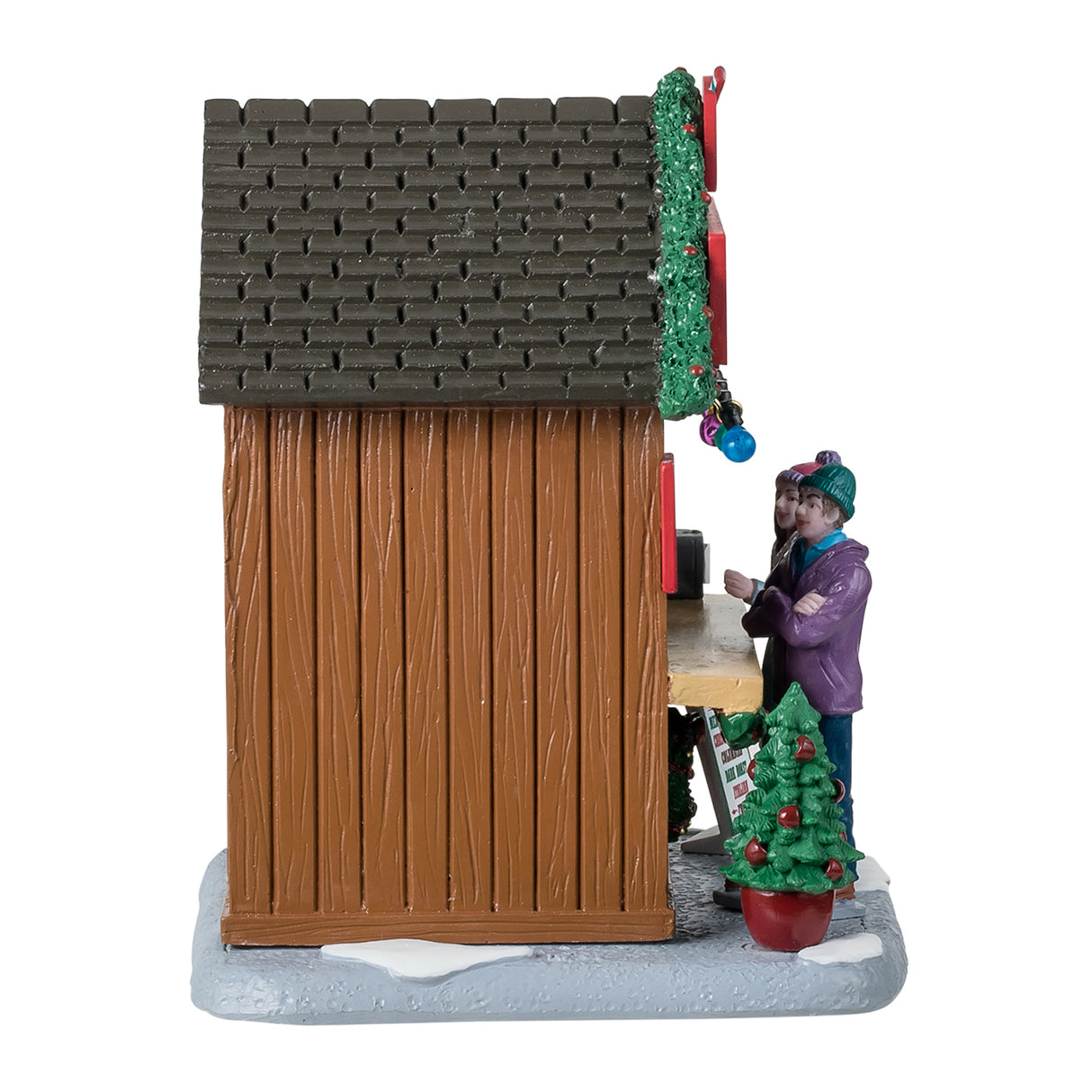 Resin table accent for a Lemax display. Designed to look like a wooden booth that's been decorated for Christmas. This is the side of the booth, showing off the wooden construction and the brown roof. There's a small tree in a red planter that's shaped like a mug.