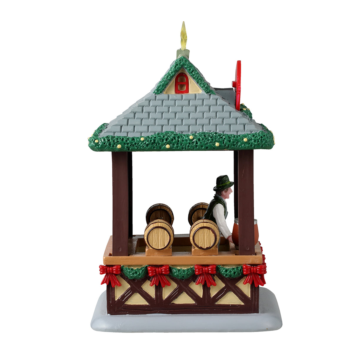 Resin table accentstar on the roof and garland on the edges of the for a Lemax display. Designed to look like a wooden booth with a stone roof. There's a star on the roof and garland around the edges of the roof. The sign reads "Glühwein." There's a smiling vendor behind the bar of the booth wearing a green top hat. The wall behind the vendor features a bunch of different bottles and there are barrels of alcohol. There's a garland around the bottom of the booth's bar and features a bunch of red bows.