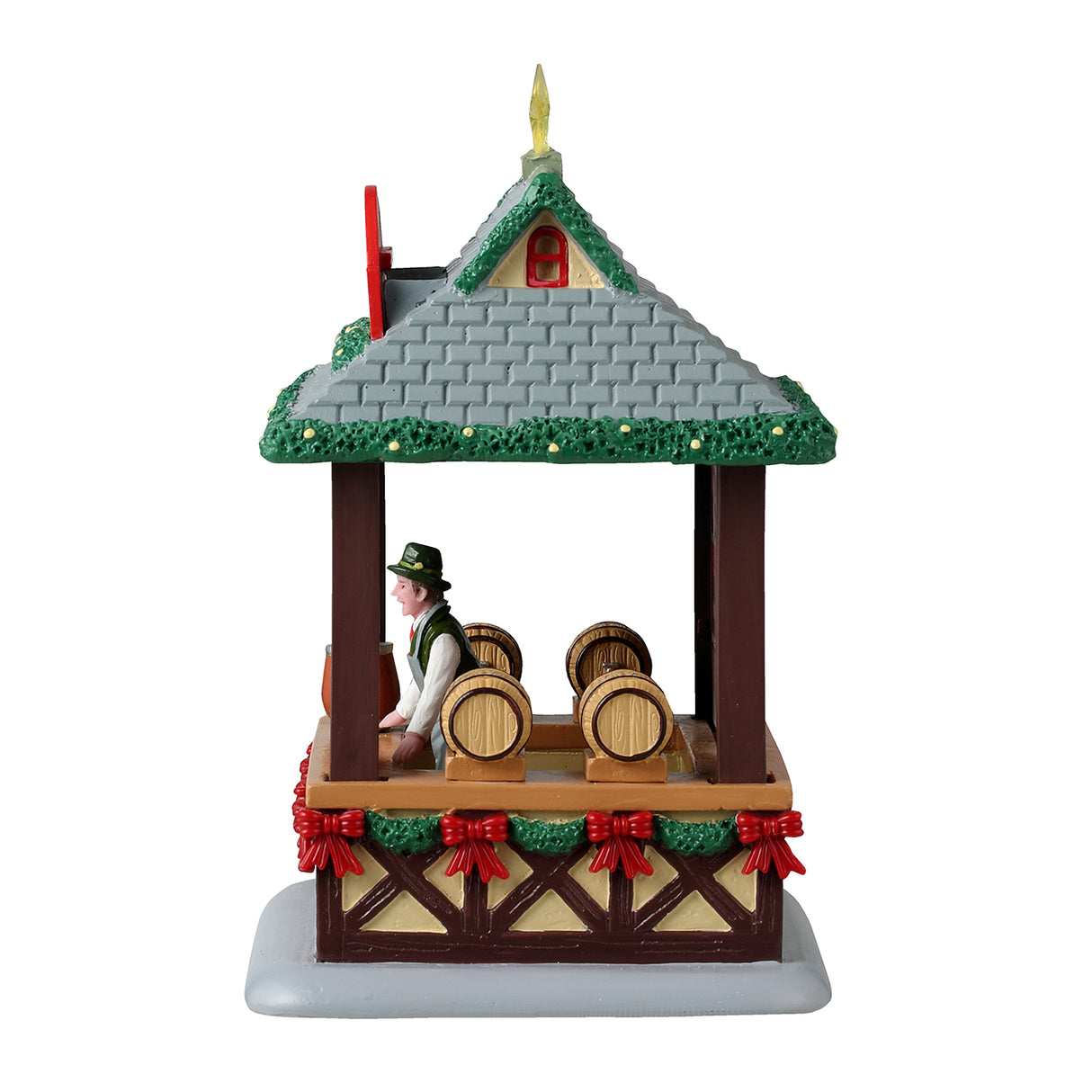 Resin table accentstar on the roof and garland on the edges of the for a Lemax display. Designed to look like a wooden booth with a stone roof. There's a star on the roof and garland around the edges of the roof. The sign reads "Glühwein." There's a smiling vendor behind the bar of the booth wearing a green top hat. The wall behind the vendor features a bunch of different bottles and there are barrels of alcohol. There's a garland around the bottom of the booth's bar and features a bunch of red bows.