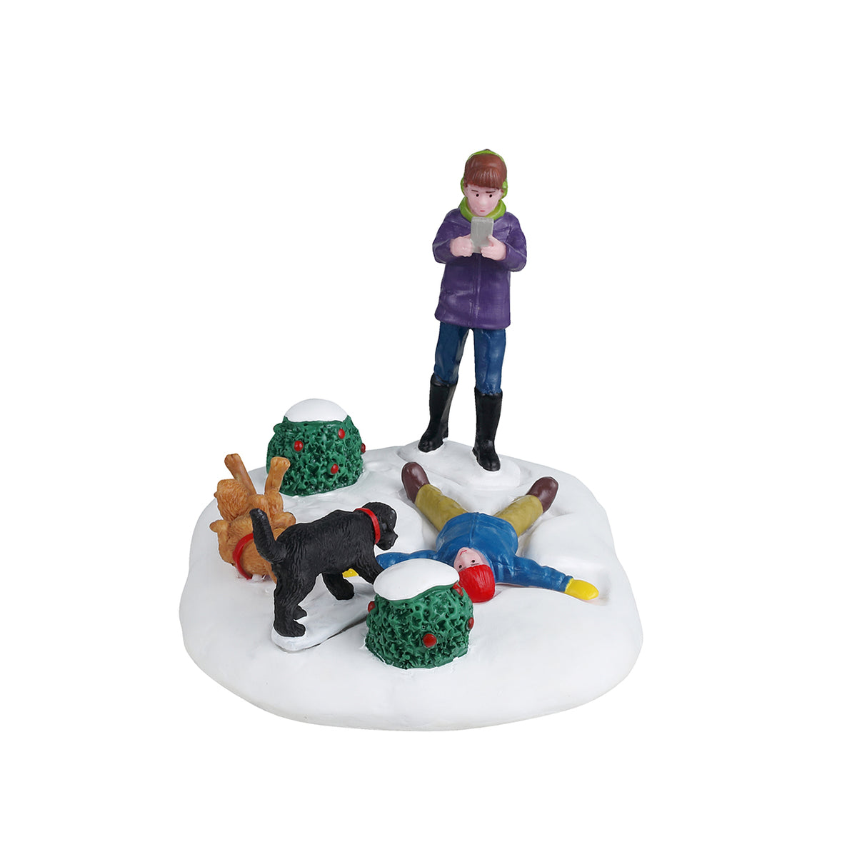 Resin table accent for a Lemax Village tabletop display. Designed to look like a young child making a snow angel while a girl takes a picture of the scene. There are two dogs and two bushes nearby. One dog is black and one is a golden brown color. The golden brown dog is laying on it's back with it's tongue hanging out. The ground is covered in snow and both kids are wearing winter clothes.