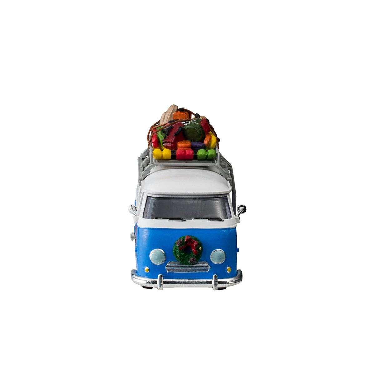 Plastic table accent for a Lemax display. Designed to look like a blue and white Volkswagen shuttle bus. The sides of the bus read "Mountain Side Shuttle Bus" and features a mural of someone skiing down a snowy hill surrounded by trees. There's a wreath on the front bumper. There's a ladder on the side leading up to the roof o the bus that's holding a bunch of ski equipment and luggage.