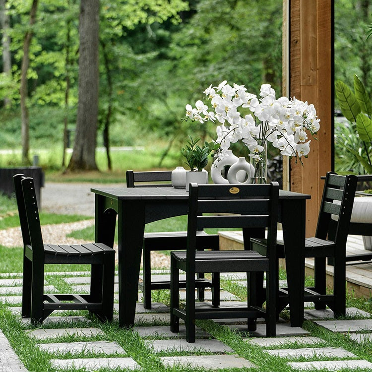 This is a lifestyle image showing the Black colored square table surrounded by matching chairs.