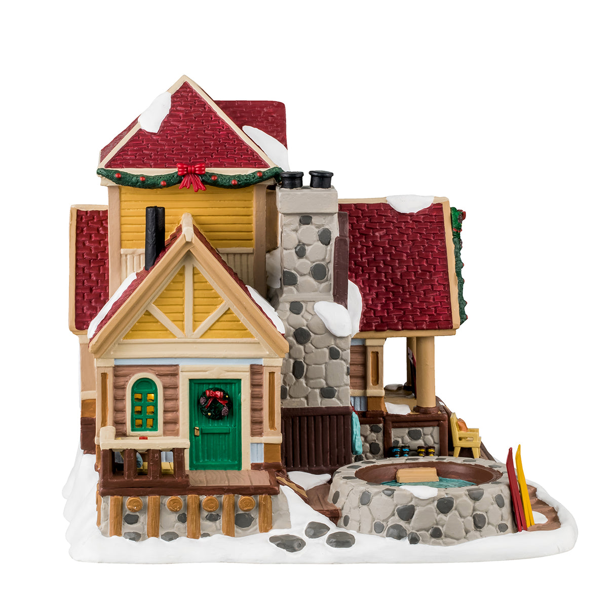 Porcelain lighted building for a Lemax display. Designed to look like a wooden cottage with a stone chimney and a stone hot tub on the porch. There's snow on the building and features wreaths and garland accents. There's a balcony with a chair and a table. There are coats hanging on the side and a few pairs of boots. There's a dog sleeping on the porch and a few pairs of skis leaning up against the stone hot tub.