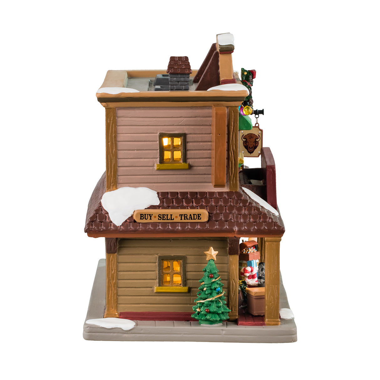 Porcelain lighted building for a Lemax display. Designed to look like a Western building. On top of the building, it says "Est. 1886." There's a large wreath near the roof and a picture of a buffalo. There's snow on the roof and a bunch of Christmas accents throughout. Accents include: a decorated Christmas tree, a Santa bag with presents and a candy cane inside, there are presents and a snowman wearing a cowboy hat.