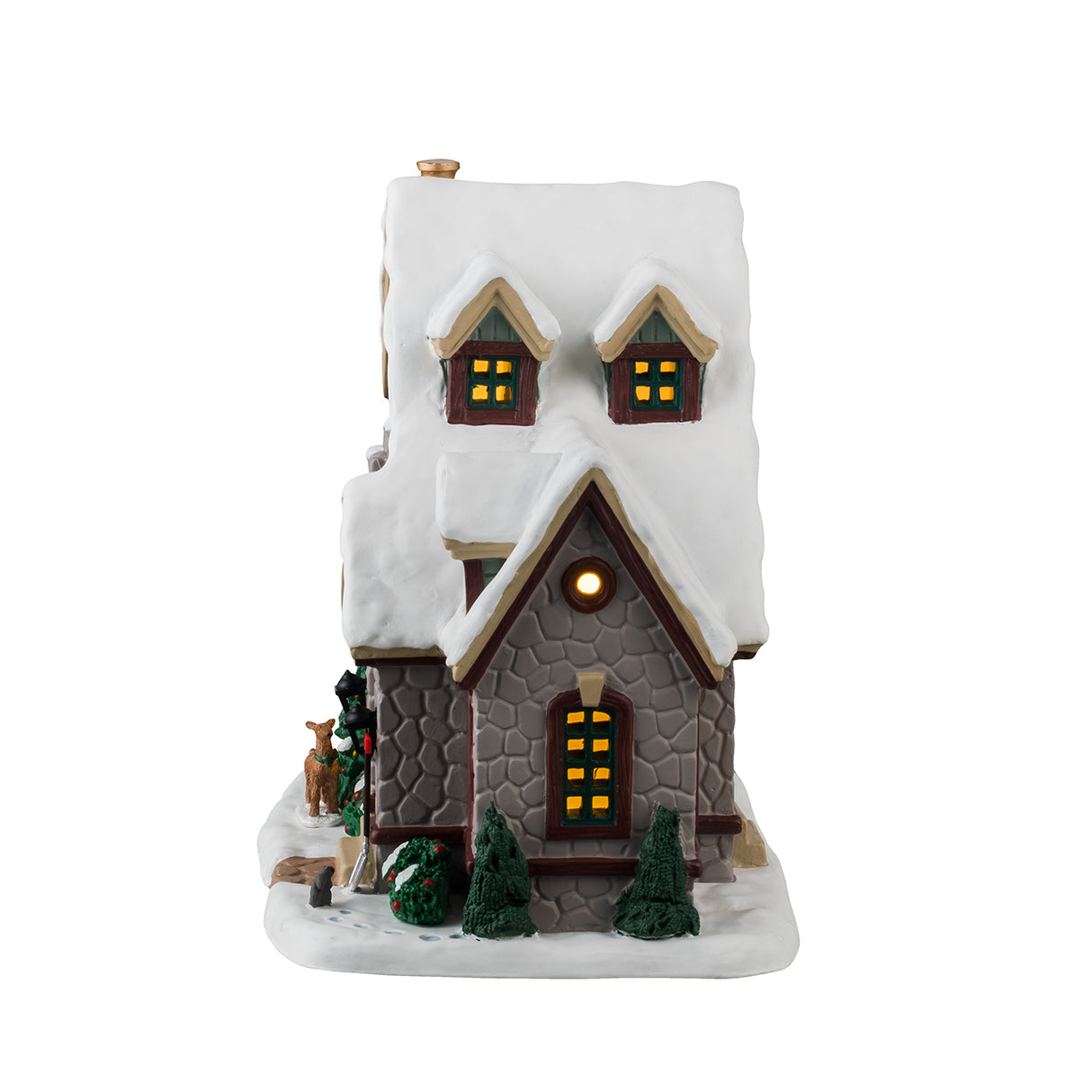 Porcelain lighted building for a Lemax display. Designed to look like a charming, stone cabin covered in snow. There are decorated wreaths and red bows everywhere. There are snow covered trees and bushes around the property. There's a deer looking into the window and a squirrel standing next to a shovel.