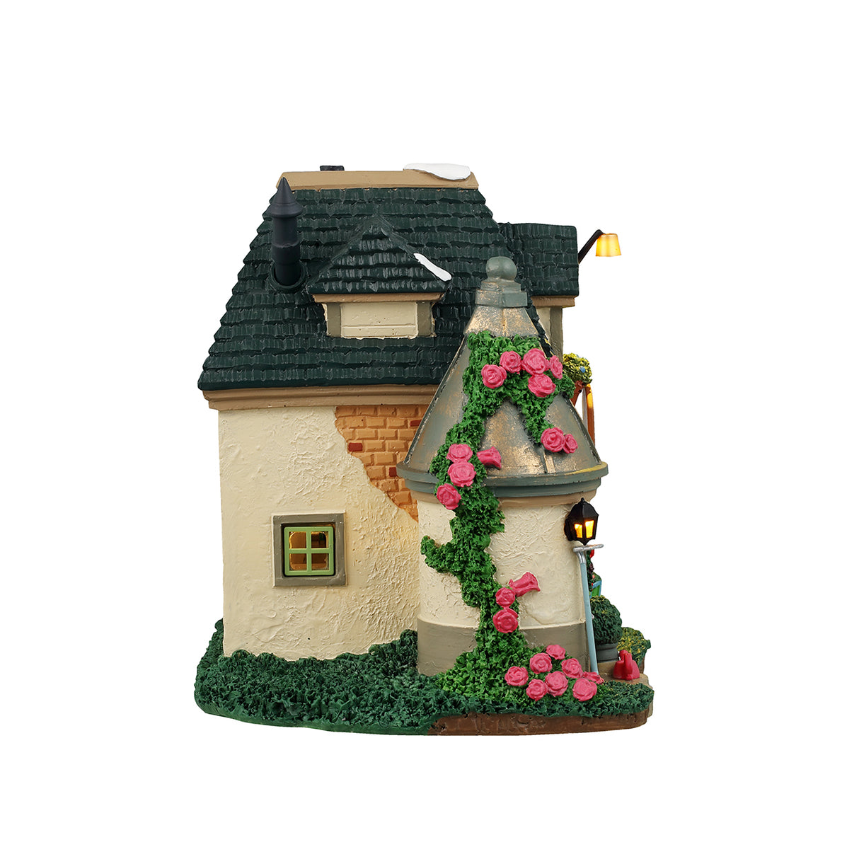 Resin lighted building for a Lemax display. Designed to look like a charming cottage covered in moss and flowers. There's a bright red door with a decorated wreath on it. There are signs that read "Farnley Moor Cottage," "Flowers" and "Please don't pick the flowers." There's snow on the roof.
