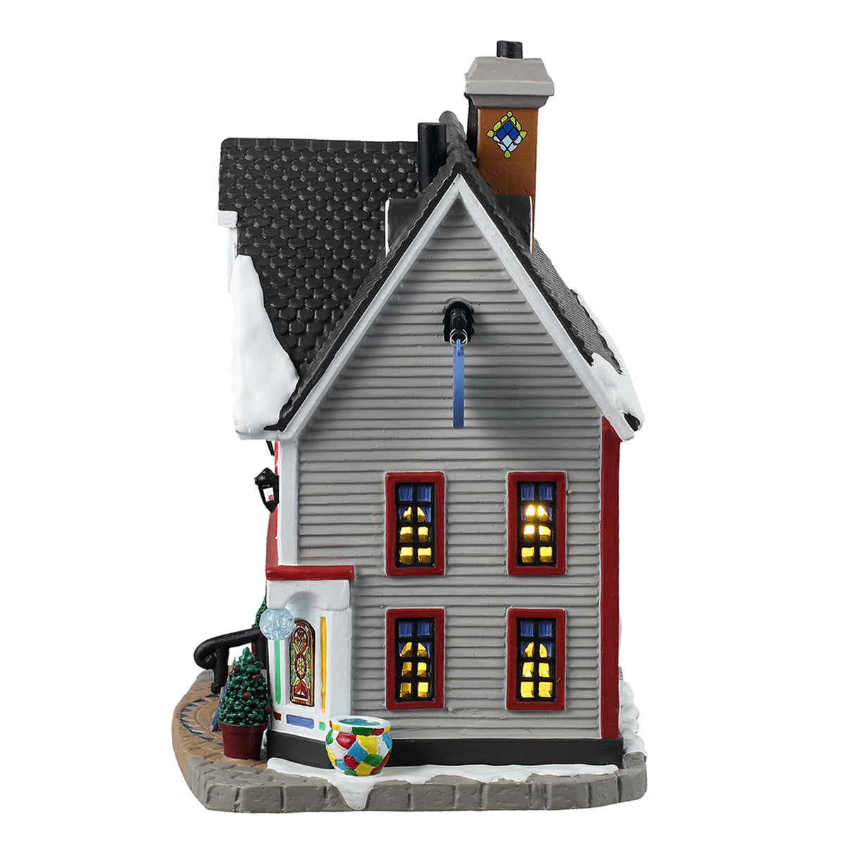 Porcelain lighted building for a Lemax display. Designed to look like a large, white house that's been turned into a shop. There's snow on the roof and most of the windows are stained glass. If you look in the window next to the door, you can see some glass vases.