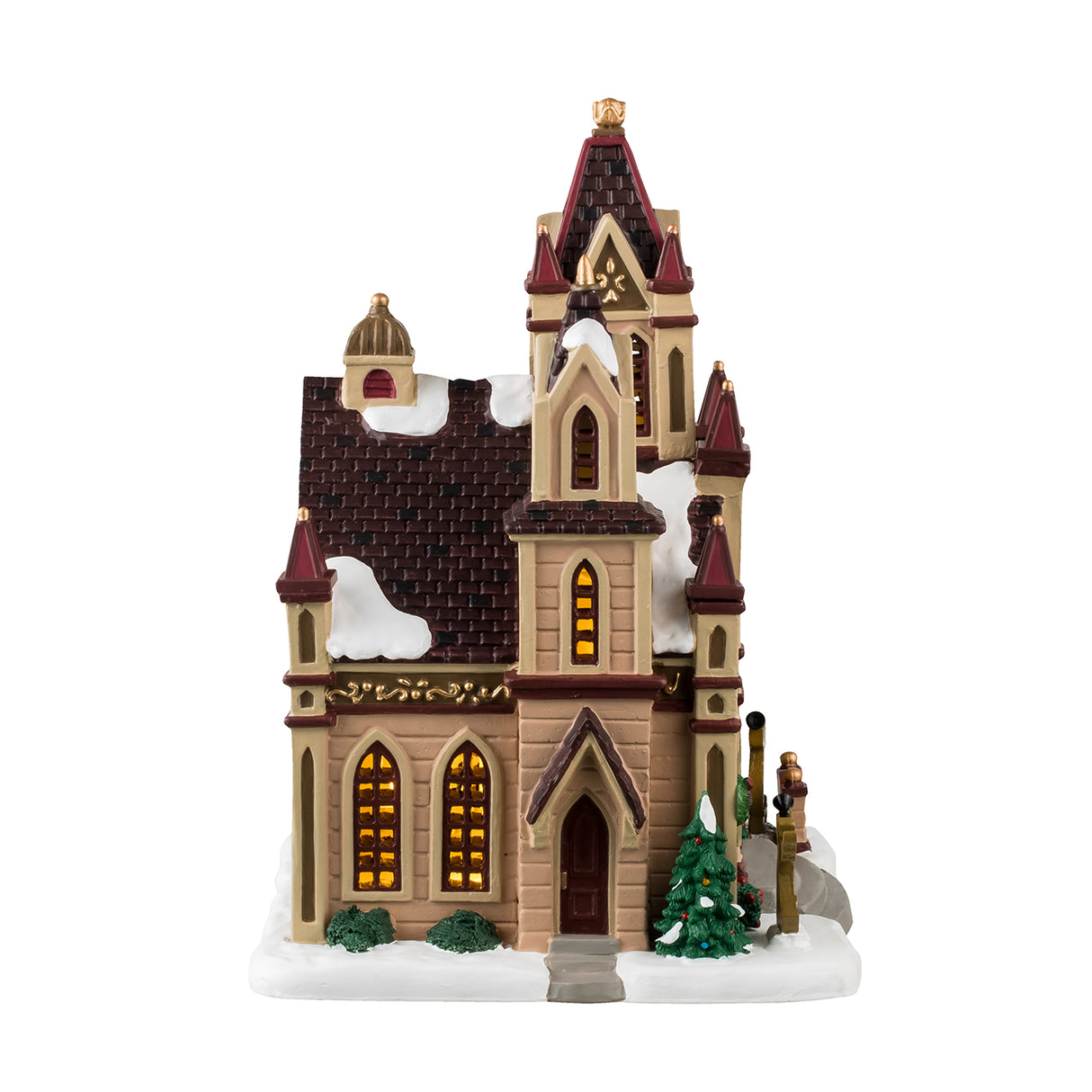 Porcelain lighted building for a Christmas Lemax Village. Designed to look like a giant cathedral. It has maroon, brown, tan and gold accents. There are three circular stained glass windows consisting of yellow, light green and orange colors. There's snow on the roof and the sidewalk. There are decorated trees, wreaths and bushes, as well as two angel silhouette decorations.