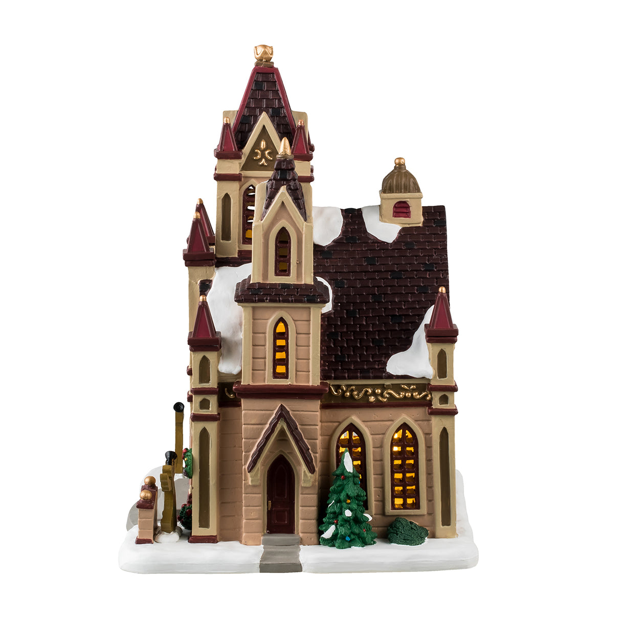 Porcelain lighted building for a Christmas Lemax Village. Designed to look like a giant cathedral. It has maroon, brown, tan and gold accents. There are three circular stained glass windows consisting of yellow, light green and orange colors. There's snow on the roof and the sidewalk. There are decorated trees, wreaths and bushes, as well as two angel silhouette decorations.