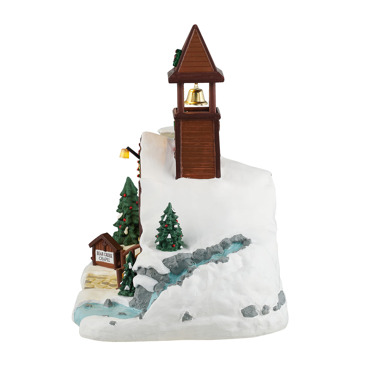 Resin lighted building for a Lemax display. Designed to look like a brown, wooden chapel with a stone chimney and a bell tower. The roof and the ground is covered in snow. There's a wreath on the bell tower, garland on the roof and two red bows on the sides of the door. The windows are stained glass. One of them is a yellow cross with a blue background. The other is a white dove with a yellow glow. There's a waterfall on the side.
