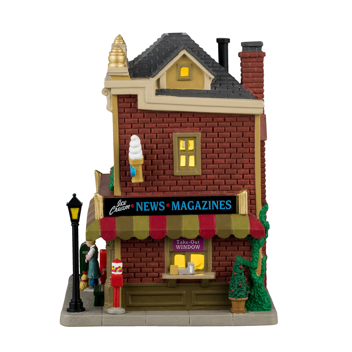 Porcelain lighted building for a Lemax display. Designed to look like a Village Drug Store. Established 1918, there's a pharmacy, sundries, groceries and ice cream. There's a mail box, a cooler with pop, a bench, a gumball machine and potted trees on the sidewalk.