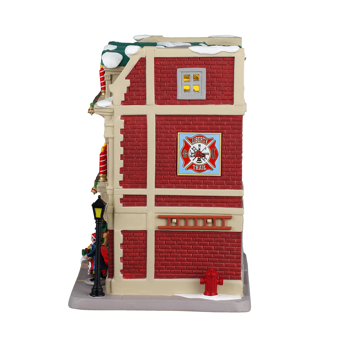 Porcelain lighted building for a Lemax display. Designed to look like a red brick fire house. There are large red and white striped candle accents, decorated wreaths and a Christmas tree. You can see the red firetruck in the garage and there's a lamppost next to the front door. There's snow on the roof and on the sidewalk.