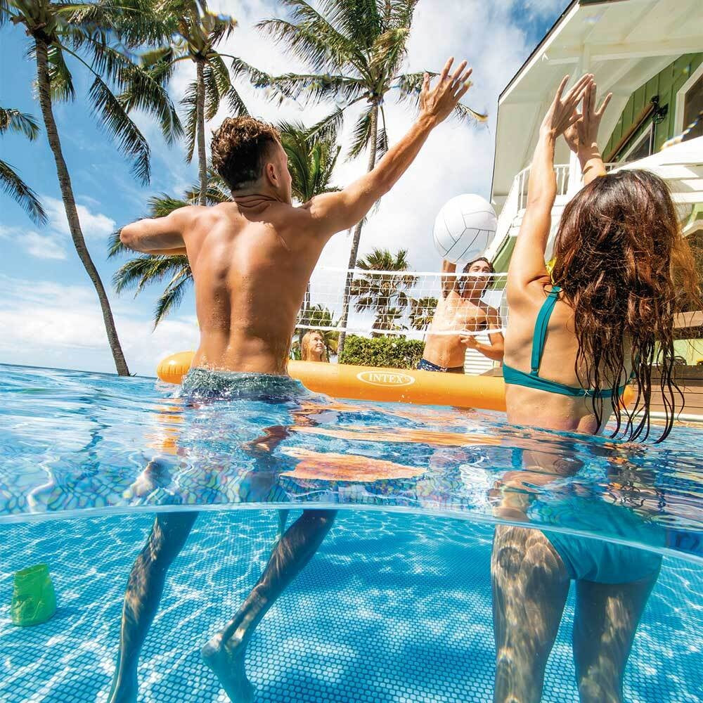 This is a lifestyle image showing people playing volleyball in some water.