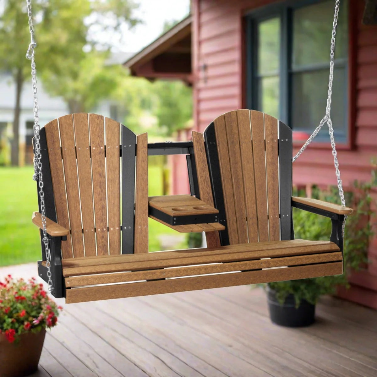 This is a lifestyle image showing the Antique Mahogany and Black colored Adirondack swing on a wooden porch.