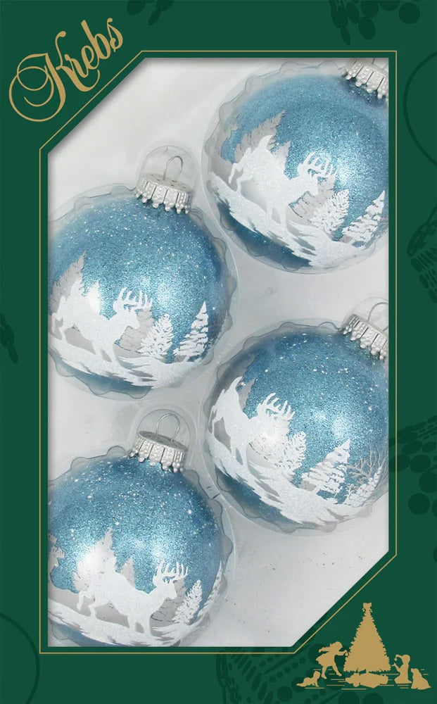 Set of ornaments decorated with light blue and white glitter. The ornaments have woodland scenes involving trees and a deer.