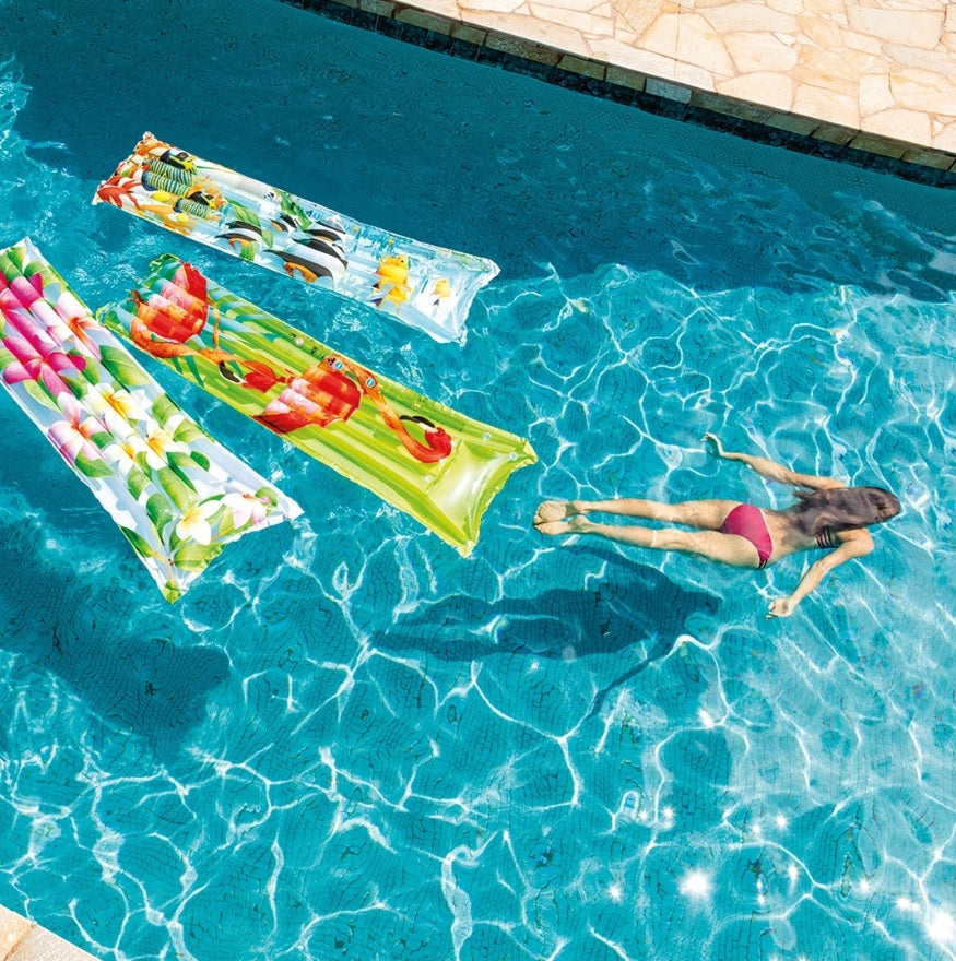 Colorful pool mattresses with different designs.