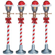 Village accents for a Lemax display. Designed to look like four lampposts. The poles look like red and white candy canes and there are Santa hats on top of the bulbs. Each lamp has a red bow tied to it.