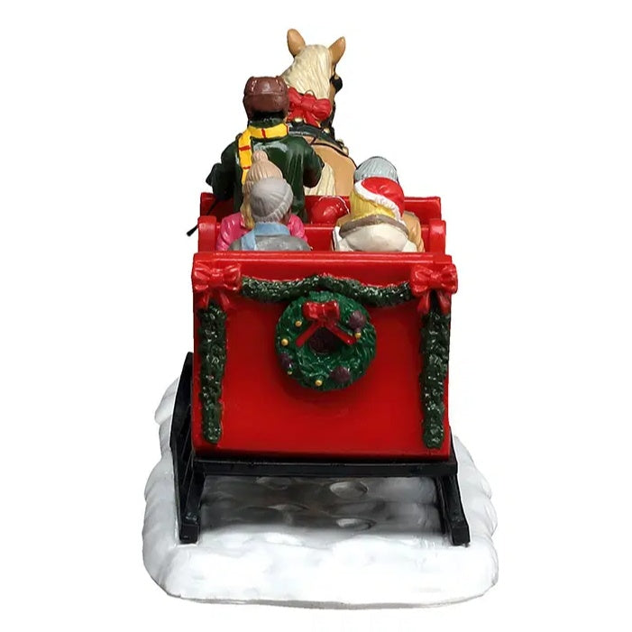 This image shows what the back of the sleigh looks like. It's decorated with garland and a wreath.