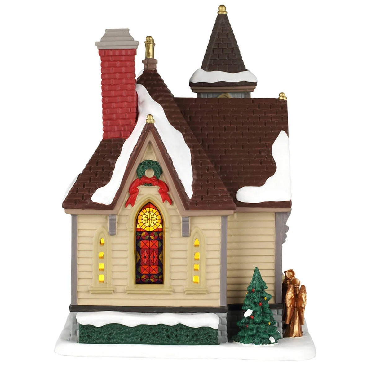 This image shows what the other side of the building looks like. There's a stained glass window, a decorated tree and a wreath with red ribbon.