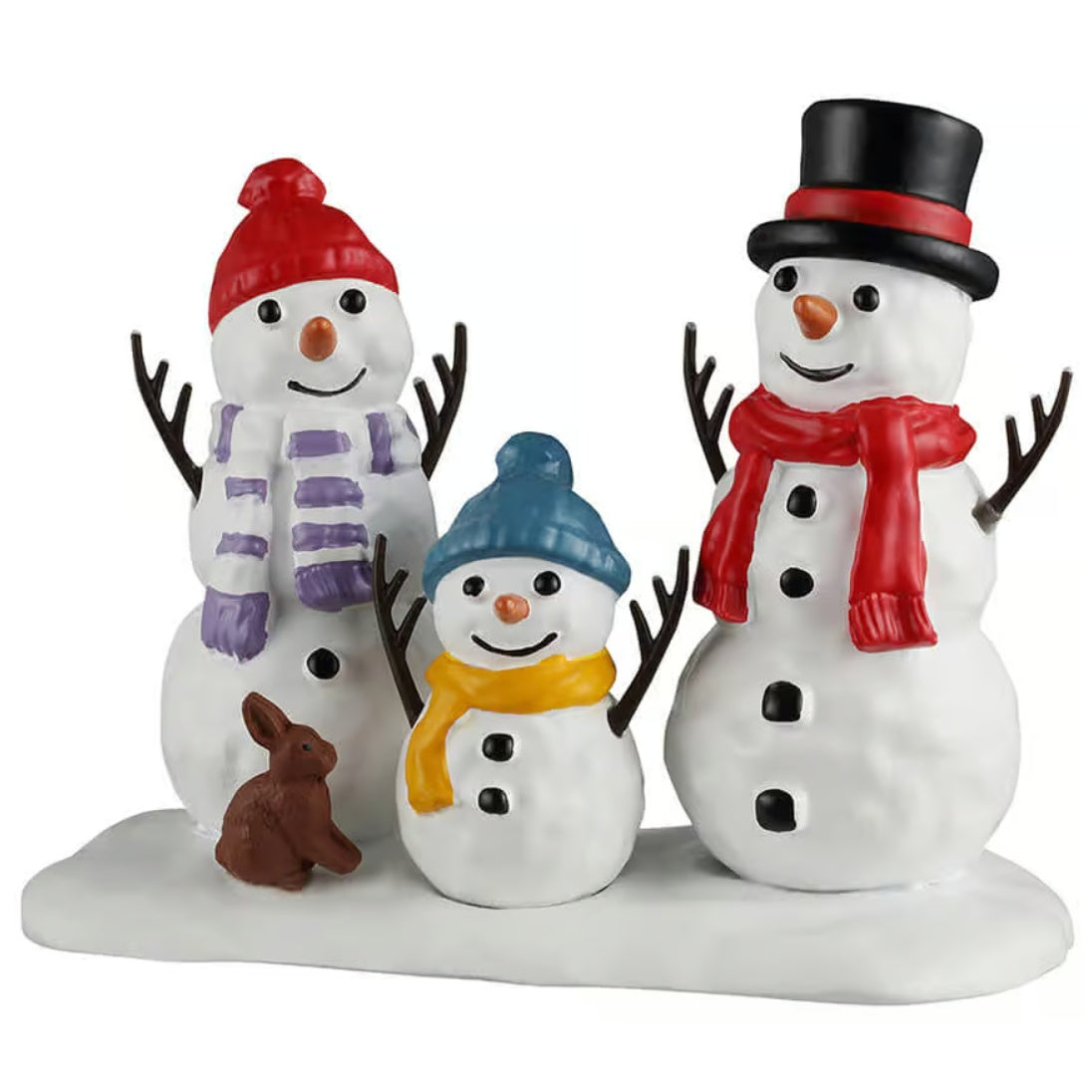 This image shows what this Lemax Santa's Wonderland figurine looks like on a white background. It was designed to look like two tall snow people and one small snow person. The tall one on the left is wearing a red knit hat and a white and purple striped scarf. The tall one on the right is wearing a black and red top hat and a red scarf. The small one is wearing a blue knit hat and a yellow scarf. There's also a brown bunny standing with them.