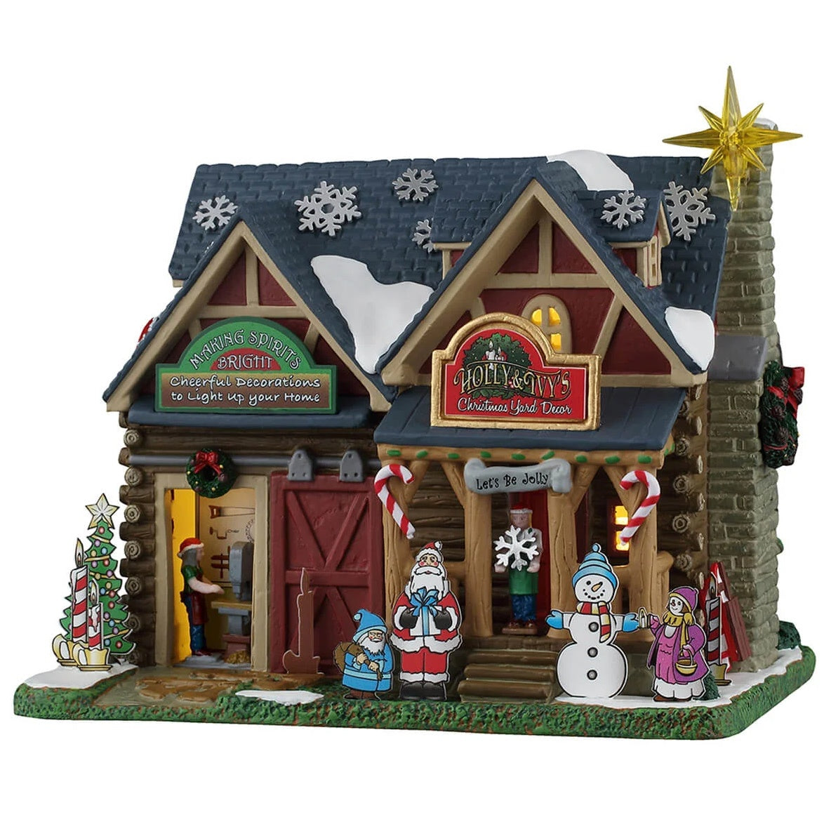 This image shows what this Lemax building looks like on a white background. It was designed to look like an old-timey cottage turned into a Christmas decoration shop. There are decorative snowflakes on the roof, cardboard cutout decorations in front of the shop and people inside working.