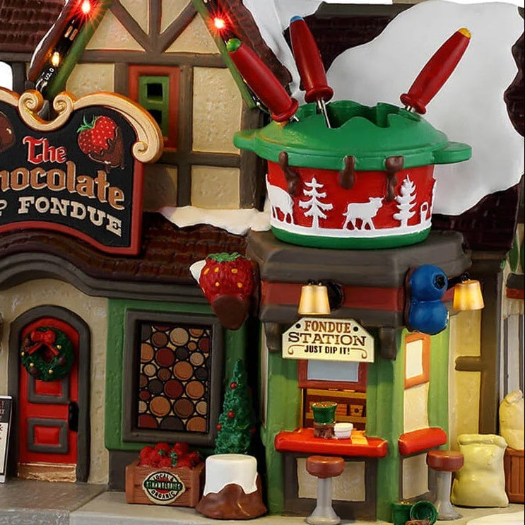 This is an up close view of the building. There are large, fake fruits like strawberries and blueberries as decorations along the roof.