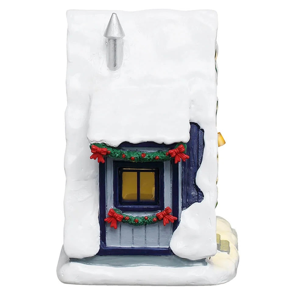This image shows what the other side of the table accent looks like. There's a window decorated with garland and red bows.