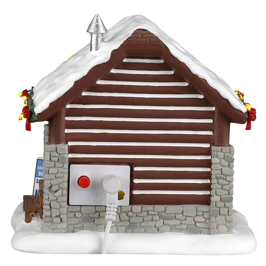 This image shows what the back of this small log cabin looks like. You can see the On/Off switch.