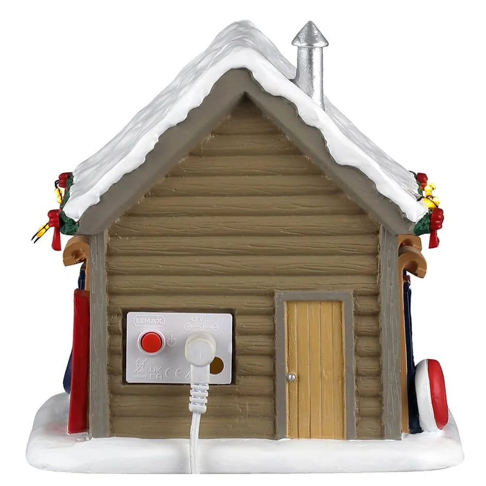 This image shows what the back of the building looks like. There's a wooden door and you can see the On/Off switch.