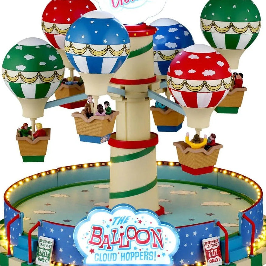 This is a zoomed in image of the first image. The hot air balloons are green, blue and red and have golden ribbon accents.