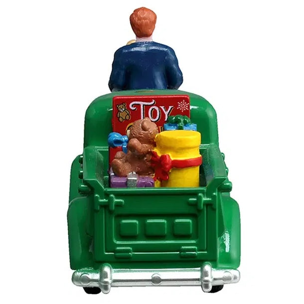This image shows what these figures look like from the back. The truck is green and in the bed of the truck, there are teddy bears and presents and toys.