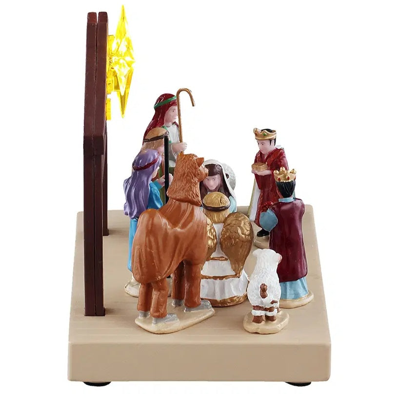This image shows what this table accent looks like from the other side. You can see two other people dressed like shepherds, one of the other Three Kings and someone dressed up like Mary. There's also a dog dressed up like a sheep.